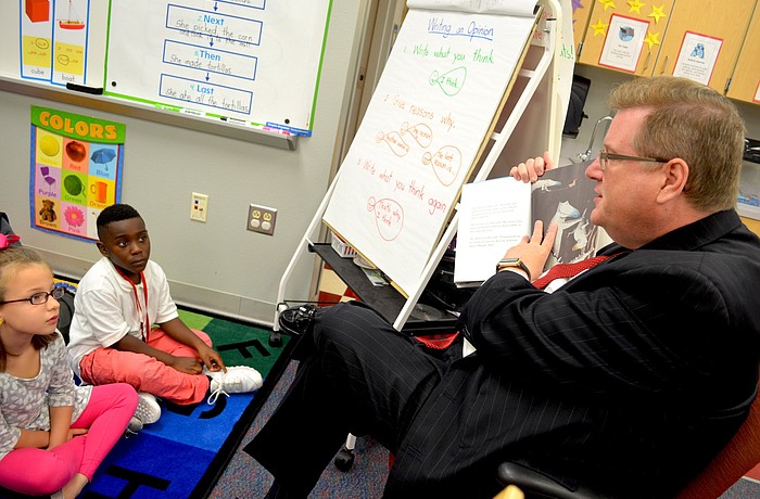 Assistant Superintendent of Operations Don Hall reads a story about a crocodile that thinks it's a duck.