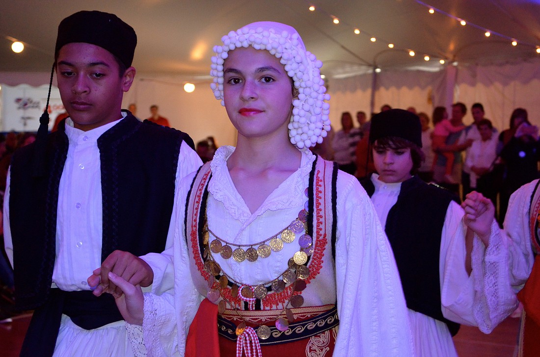 Christine Gianoplus leads the Hellenic folk dancers before an audience at the 2015 Greek Glendi festival.