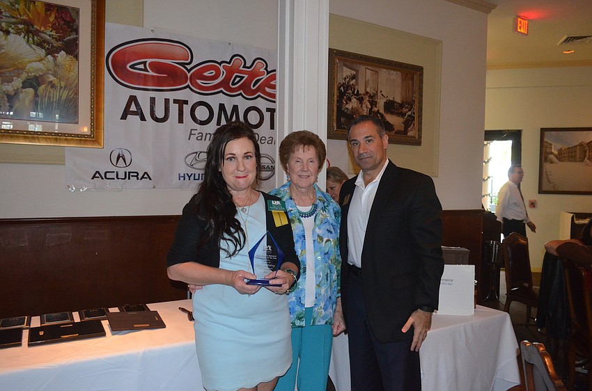 Penelope Mabrey, of SERVPRO of Bradenton and Norm Mallard Ambassador of the Year, with Nelle Mallard and 2015 Chairman of the Board Jeff Mayers, of the Resort at Longboat Key Club