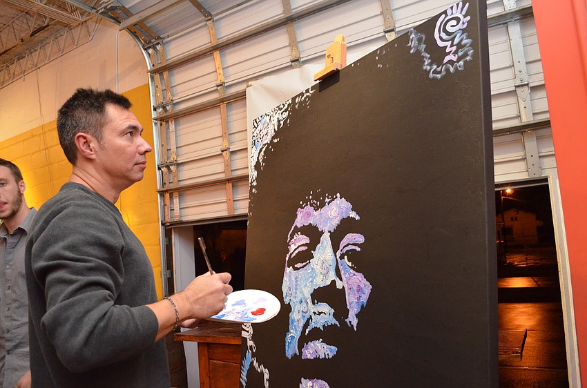 Artist Matt Pecson continues his work in progress during the event for guests to see.