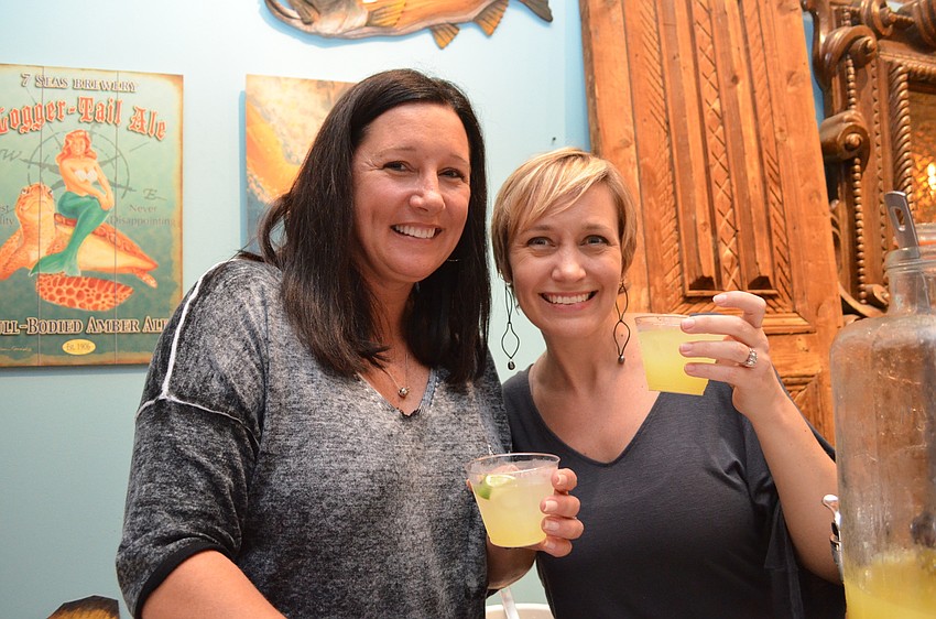 Suzan Waldschmidt and Arin Jackson toast with the event signature cocktail a 