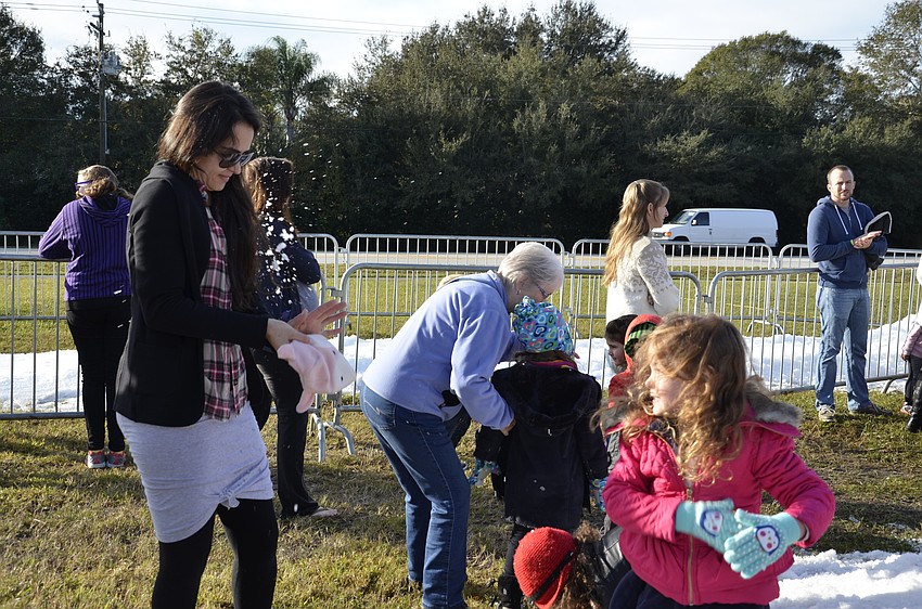 Ayla Rodriques deflects a snowball thrown by her daughter, Annah.