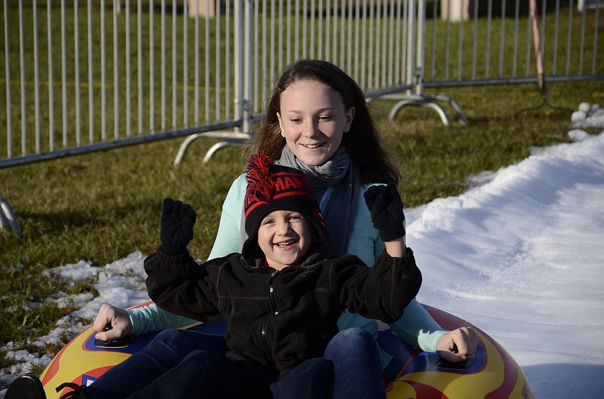 Grace Weichert slides down the slop with Blake Rogers.