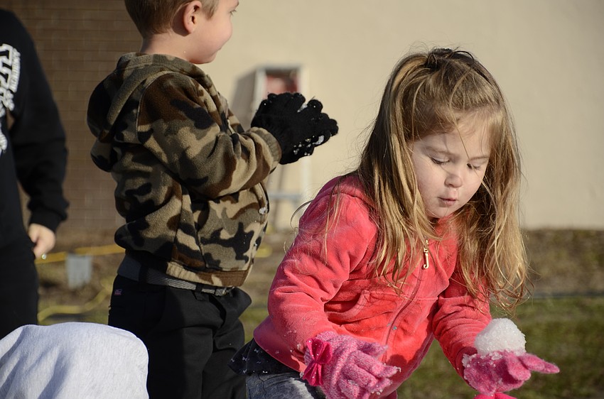 Kinleigh Delk crafts a snowball.