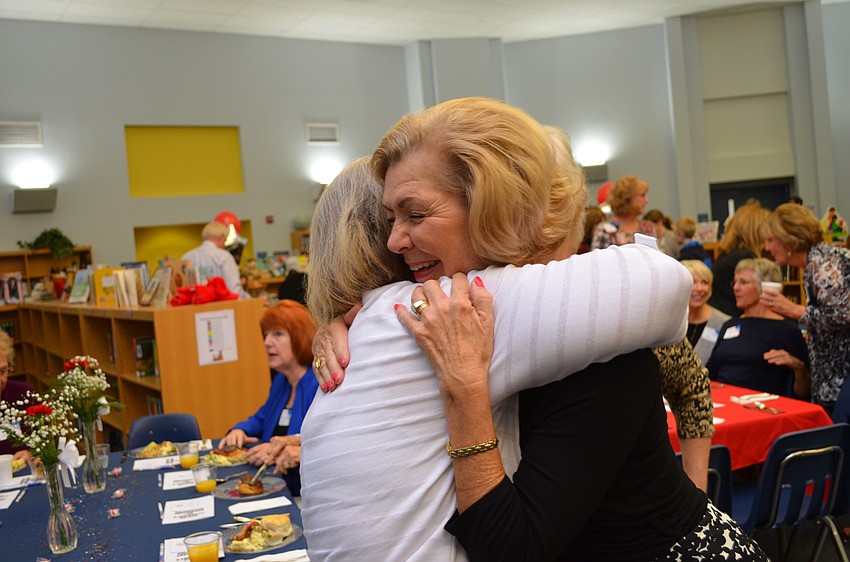 Old friends Bennie Hansen and Pam Monson greet each other.