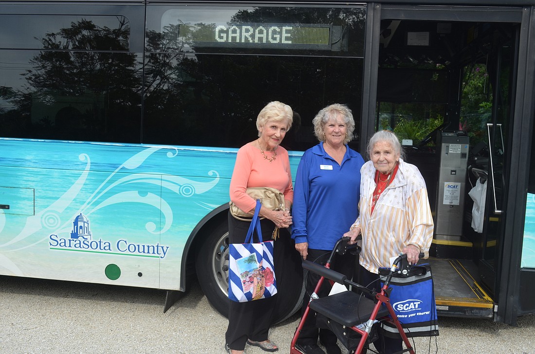 Judy Blair, bus operator Karen Jara and Pat Curcuru
