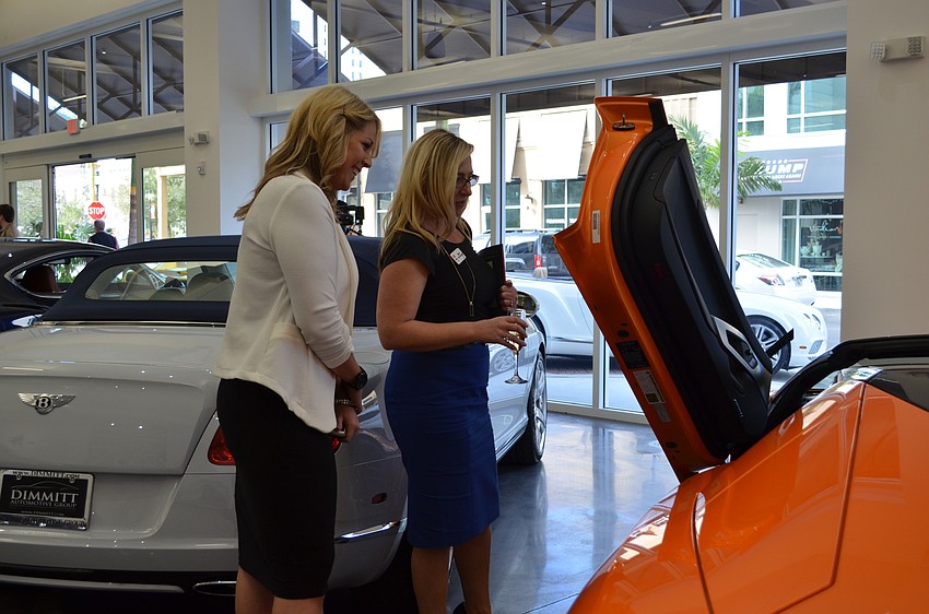 Meredith Headings and Allison Imre check out a Lamborghini.