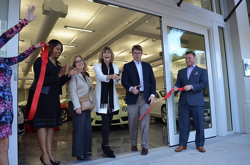Sarasota City Commissioners Shelli Freeland Eddie, Liz Alpert, Suzanne Atwell help Peter Dimmitt cut the ribbon to the new Dimmitt Automotive Sarasota Studio Friday, Jan. 29.
