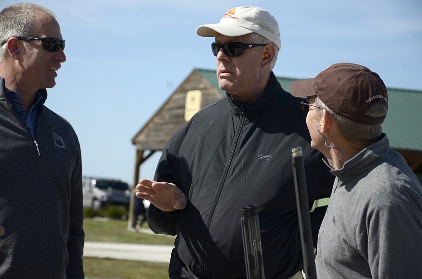 Chris Ciaccio of IMG Academy, Bob Bartz with the Chamber, and Mac Carraway of Carraway Consulting chat between a station.