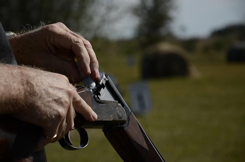 Don Baugh of Vanessa's Fine Jewelry loads his Caesar Guerini shotgun.