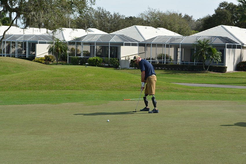 Marine Corp. Josh Langston-White tries to sink a long putt during the Homes For Our Troops benefit at Rosedale Golf and Country Club.
