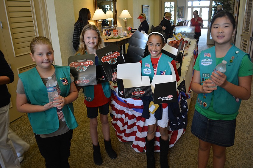 Sage Hagelberg, Coral LeBon, Jada Banks and Hope Tudor, all of Girl Scouts Troop 180 out of Braden River Elementary School, handed out snack boxes before the tournament.
