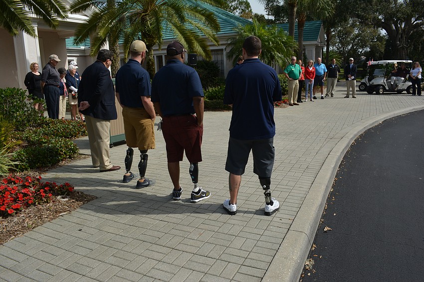 The veterans listen to comments made before the benefit tournament.