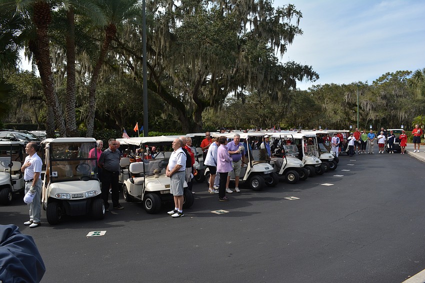 Golfers pause to honor America before the Homes For Our Troops benefit golf tournament at Rosedale Golf and Country Club.