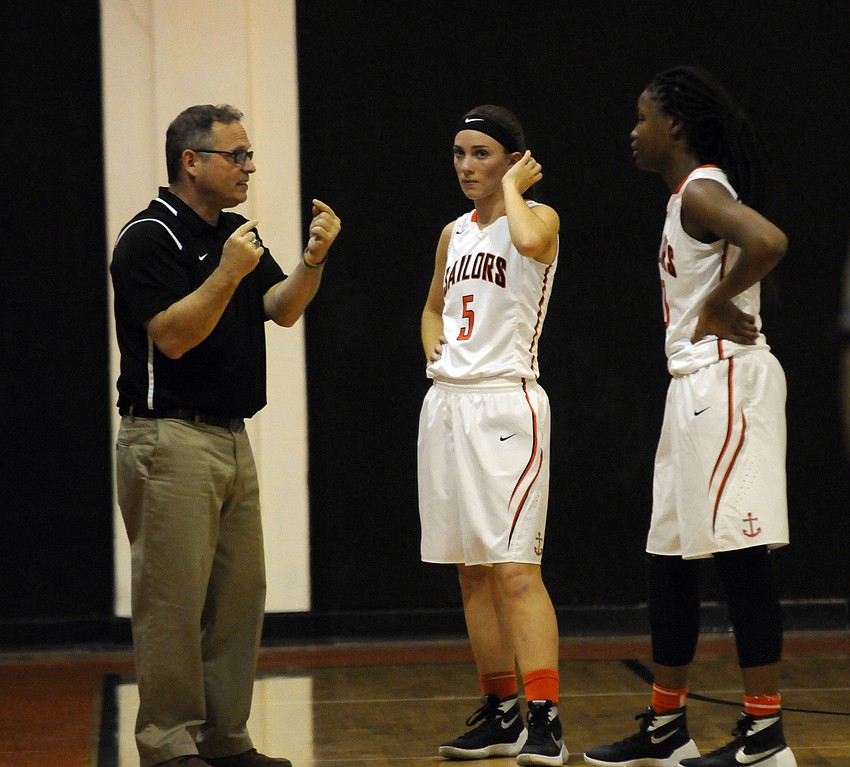 Sarasota coach Rob Jutras goes over the game plan with Josie LeBlanc and Imani Jones in the first half.
