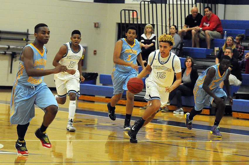 ODA junior forward Jake Garrett brings the ball up the court for the Thunder in the second quarter.