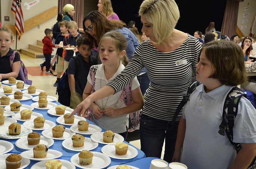 Sarah, Jessica and Kaylee Pendry pick out what flavor of muffin to eat.
