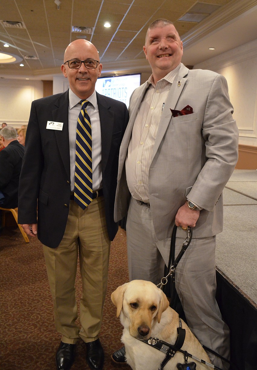 Southeastern Guide Dogs CEO Titus Herman with Paws for Patriots co-founder Michael Jernigan and his guide dog Treasure.