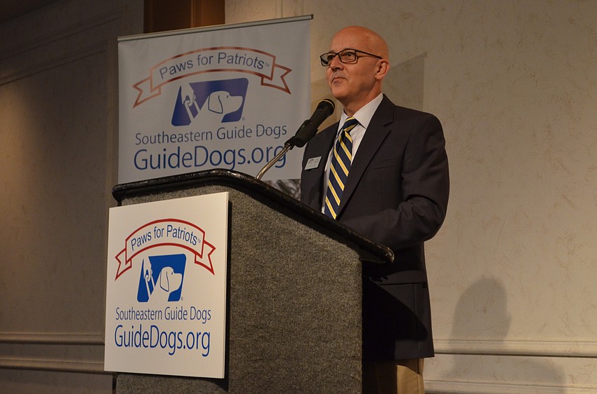 Southeastern Guide Dogs CEO Titus Herman addresses guests at the inaugural Paws for Patriots breakfast.