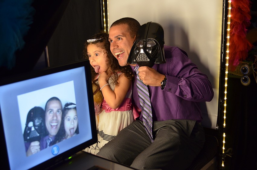 Auvrie and Casey Jimenez get silly in a photo booth.