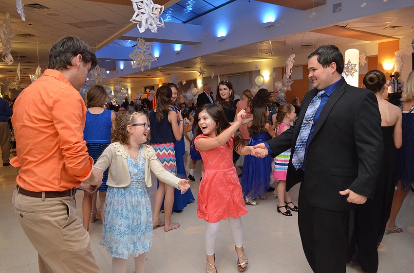 Gwen Precourt and Ilanna Herbert enjoy a dance with their fathers Brian Precourt and Mike Herbert.