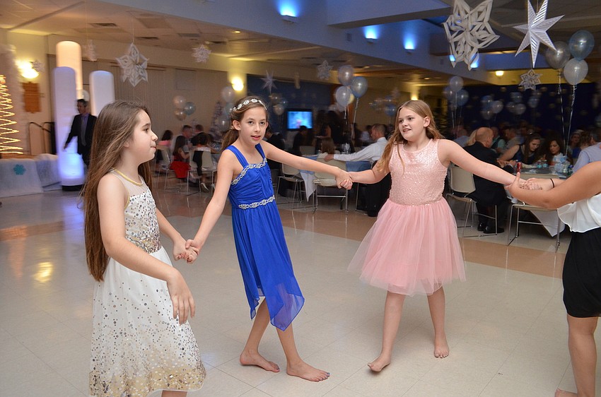 Madelyn Jessup, Lyia Lester and Payton Nayder form a circle on the dance floor.
