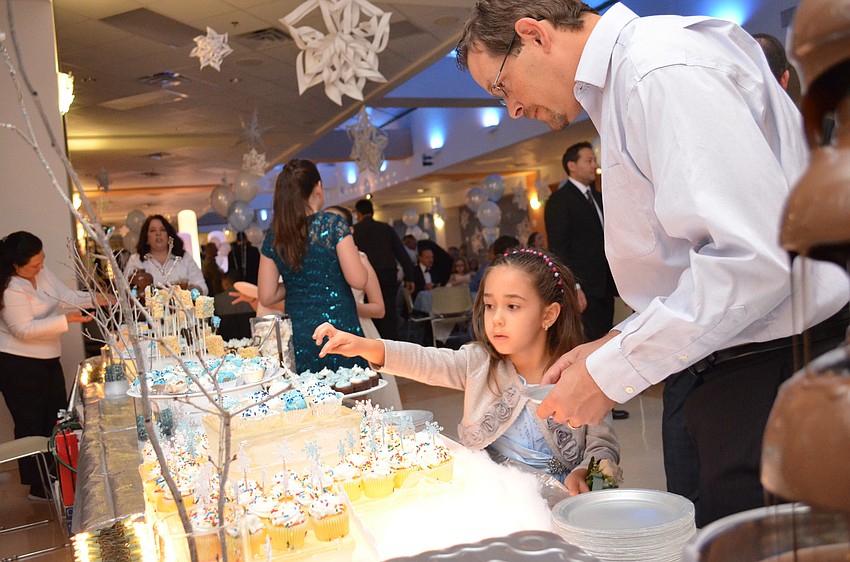 Sofia Golembeske picks out dessert with her father Andrew.