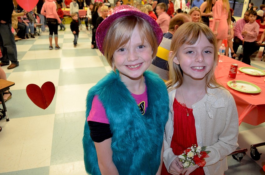 Third-graders Elise Combs and Skylar Armstrong take a break from dancing.