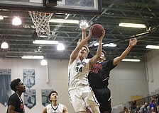 Lakewood Ranch sophomore forward Jack Kelley muscles his way to the hoop in the first quarter. (Photos courtesy Brian Blanco)