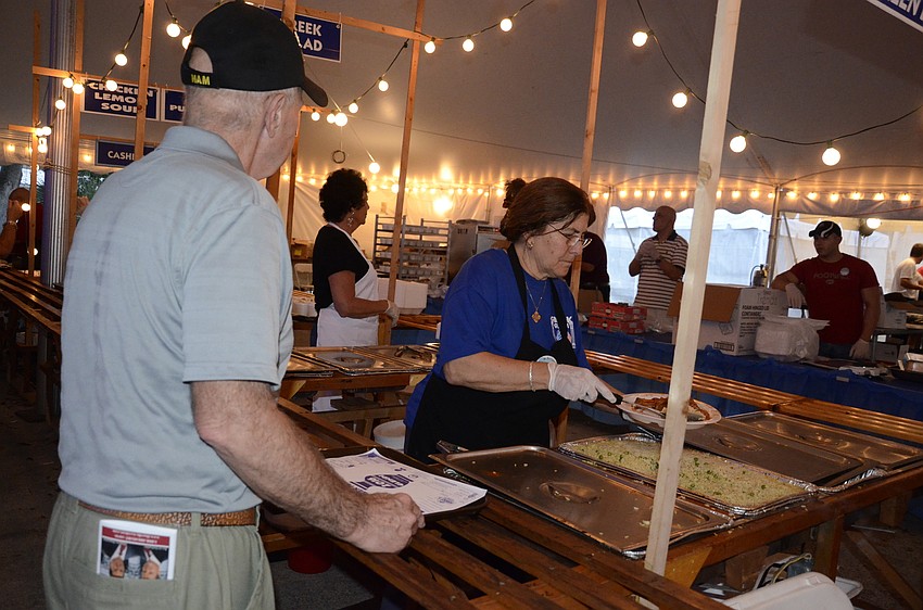 Jim Alexion of Englewood gets some sides for his meal from Aya Konstantinou.