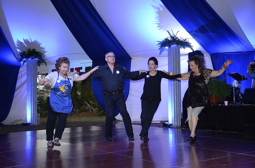 Diane Kontonickas, Steve Zeris, Dina Hobson and Mary Duvalris, volunteers and vendors at the festival, do a traditional Greek dance.