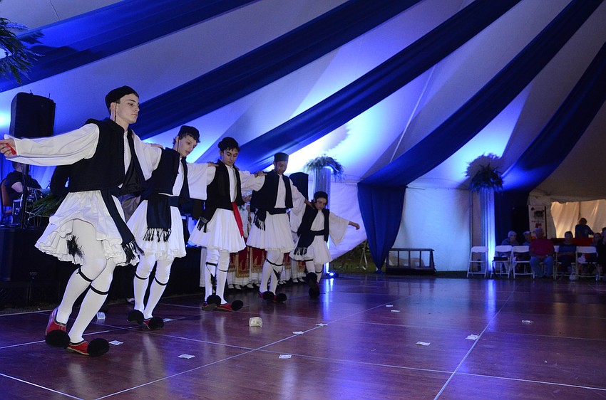 John Rometo, Robert Smith, Demetri Martins, Peter Balos and Romsey Choueiri dance in traditional Greek garb. The boys are members of the church.