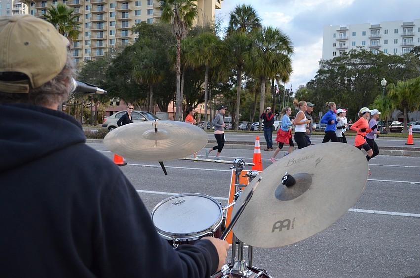 Gavin Michael plays drums for Kettle of Fish as participants race by.