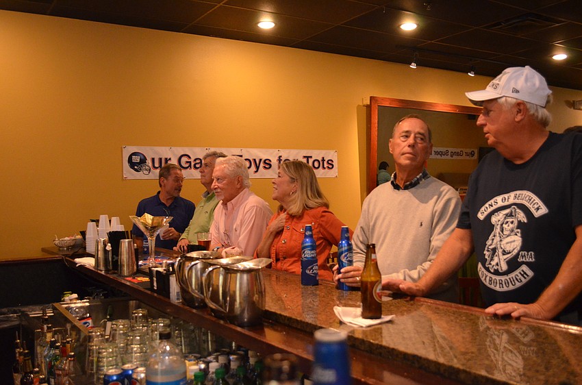 Members watch the start of the game at the bar.