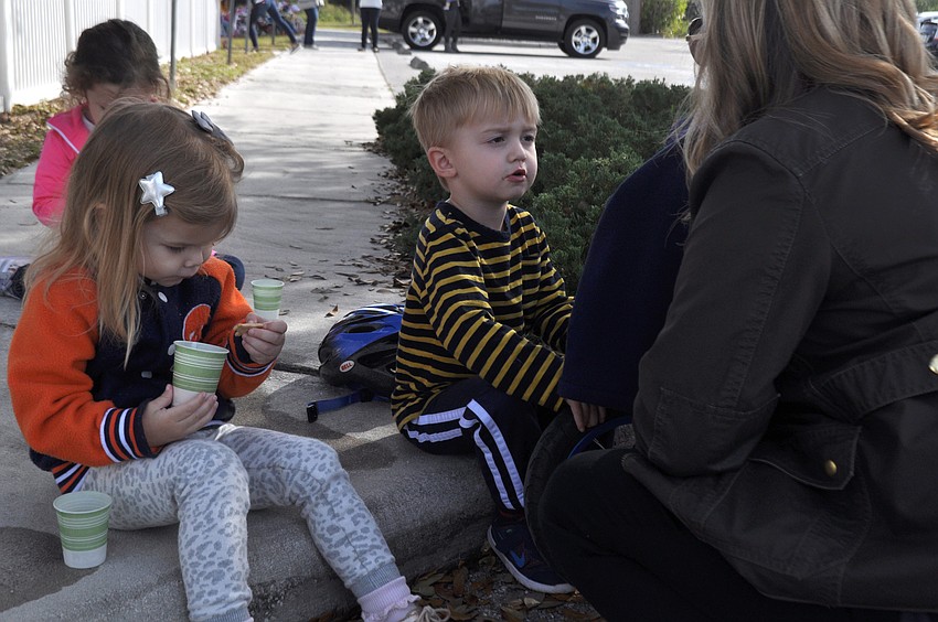 Georgia Blevins and Ryan Sirianni eat snacks with Ryan's mom, Sarah Siranni.