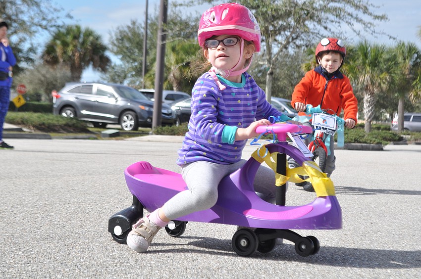 Reese Donnelly pushes herself along during the trike-a-thon.