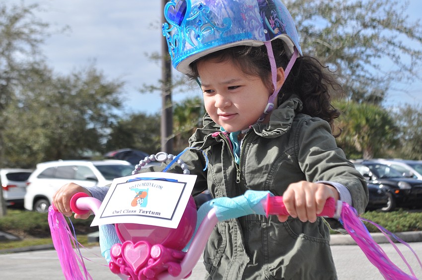 Taytum Roenicky focuses on her bicycling drive.