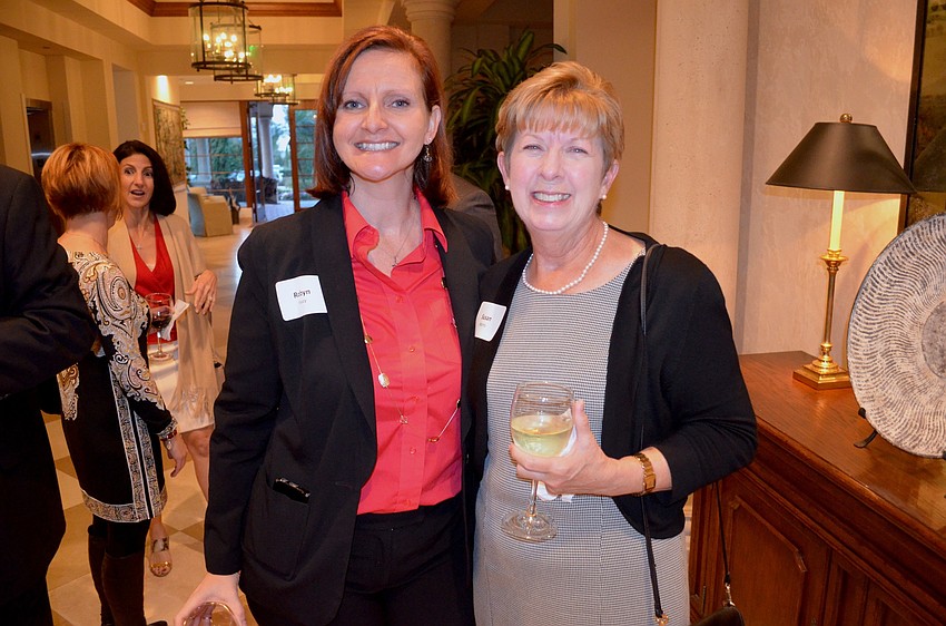 Robyn Faucy and Susan Morris, of the Education Foundation of Sarasota County, enjoy cold drinks and good company.