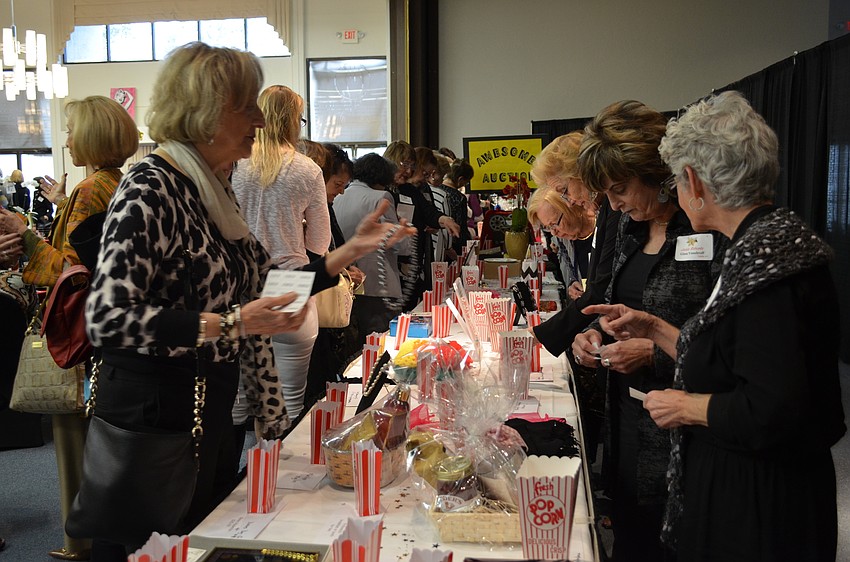 Guests placed bids on silent auction items at the beginning of the fashion show.