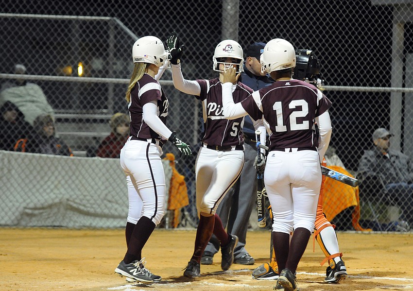 Braden River's Bethaney Keen, Sarah Crawford and Zaire Yancy celebrate after the Pirates take an early 3-0 lead.
