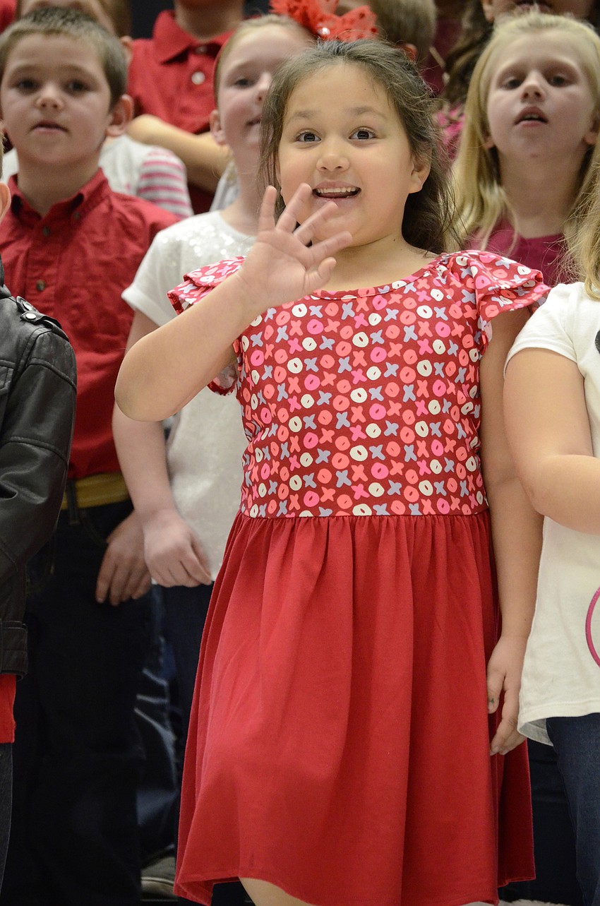 Audri Rivera waves to her family.