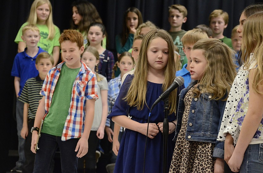 Fourth-graders Isabella McCracken and Alanna Bray read off statistics about Earth Day.