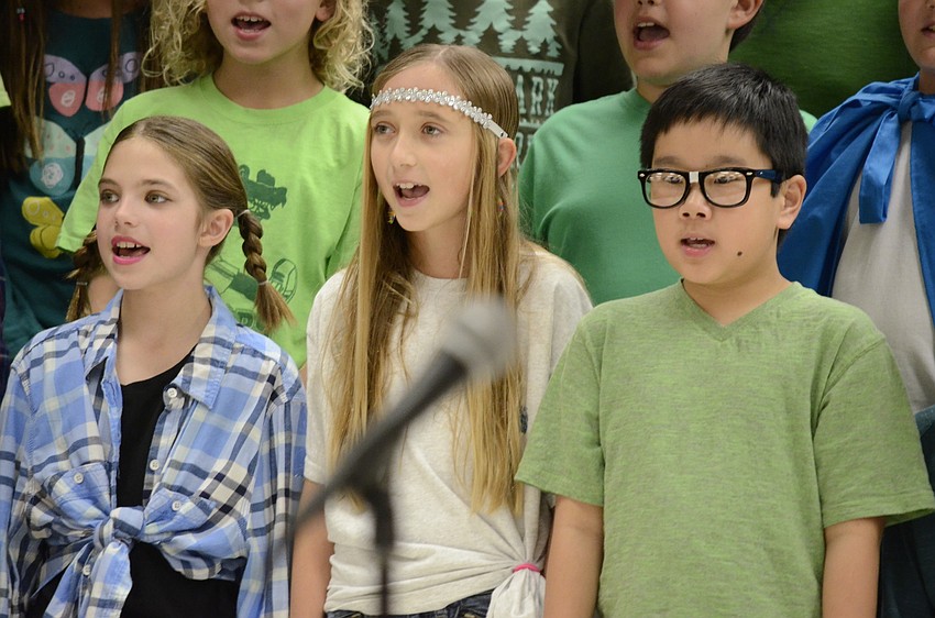Gwynneth Rustin, Alexa Tzelepis and Spencer Boyer sing for Earth Day.
