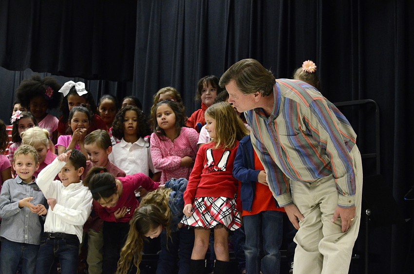 Music teacher Tim Hamand takes a bow with his first-graders.
