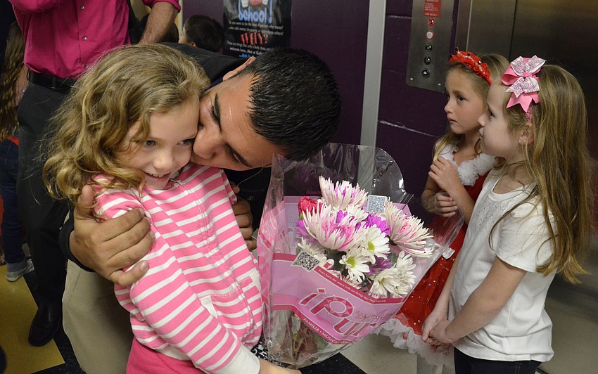 Adriana Campbell gets flowers and a kiss from her dad, Wade.