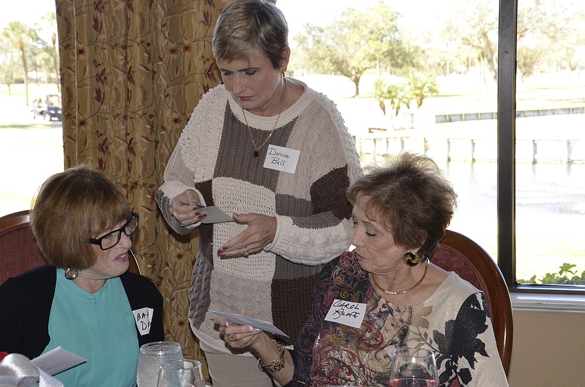 Barbara Denni and Carol Ruoff get their door prizes from Denise Bell.