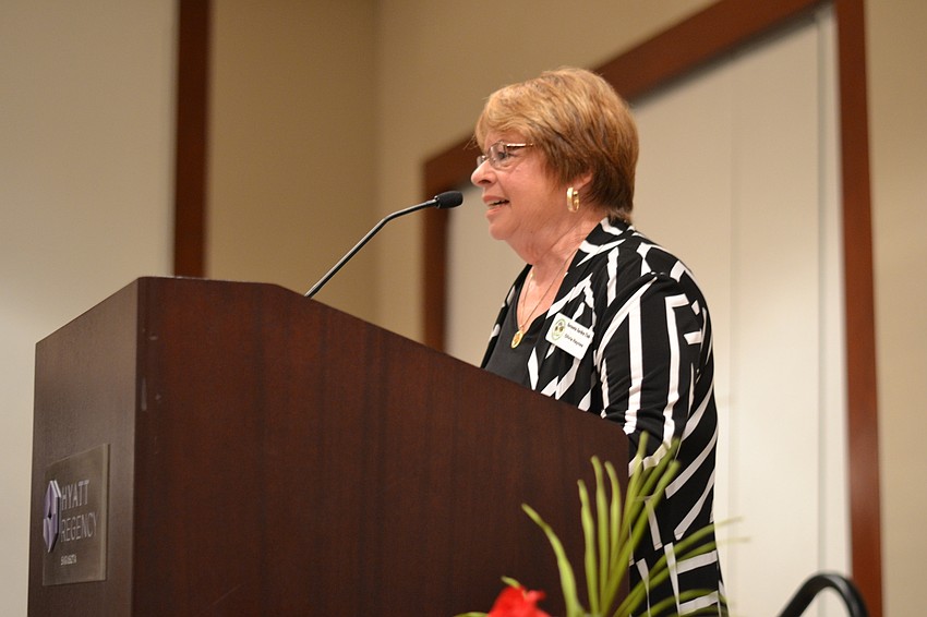 Sarasota Garden Club President Olivia Haynes welcomes guest to the Tutta Bella Fashion Show.