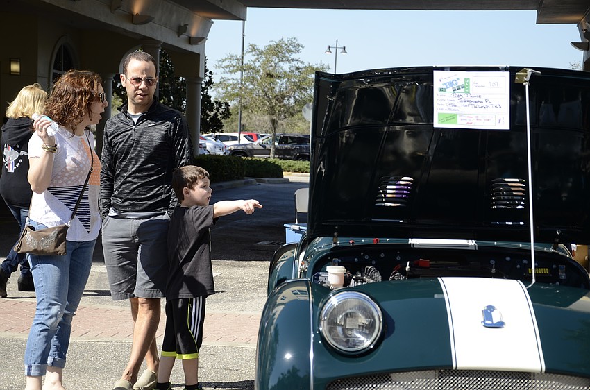Hila Reichman and Josh and Ilan Podietz of New York regard a 1956 Triumph TR3.