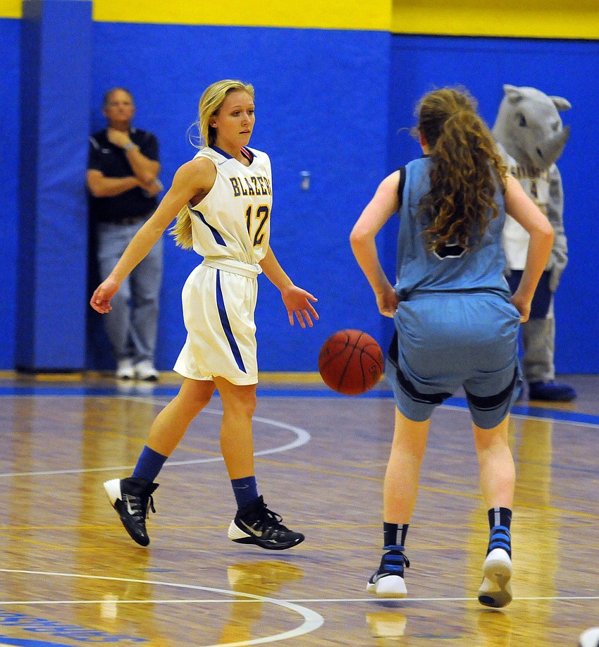 Sarasota Christian senior McKenize Lantz brings the ball up the court in the first quarter.