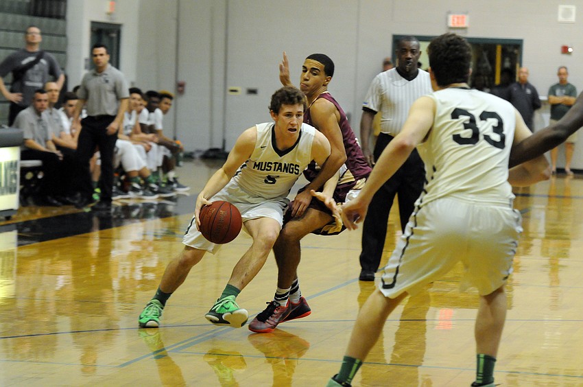 Lakewood Ranch junior guard Sam Hester dribbles around a Riverdale defender in the first half.